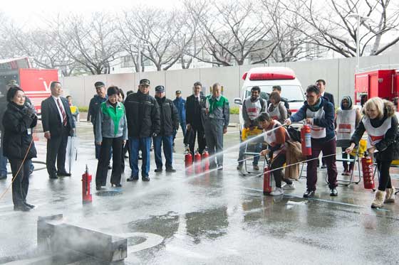 Drill participants practice using fire extinguishers
