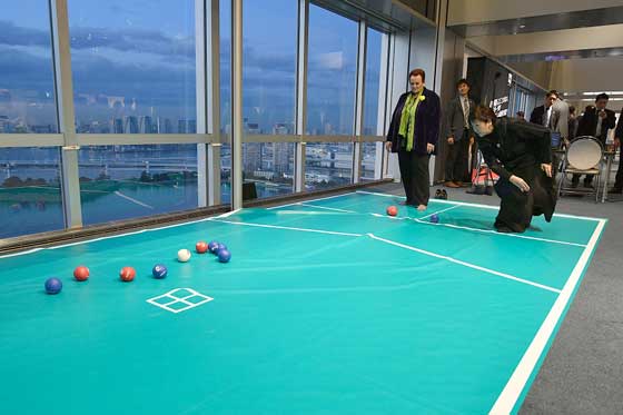 Governor Koike plays boccia with an official from overseas